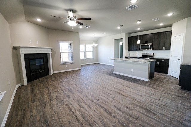 504 Lakeway Ln, Justin, TX 76247 - kitchen with a ceiling fan, stainless steel appliances, open floor plan, dark wood finished floors, and a fireplace