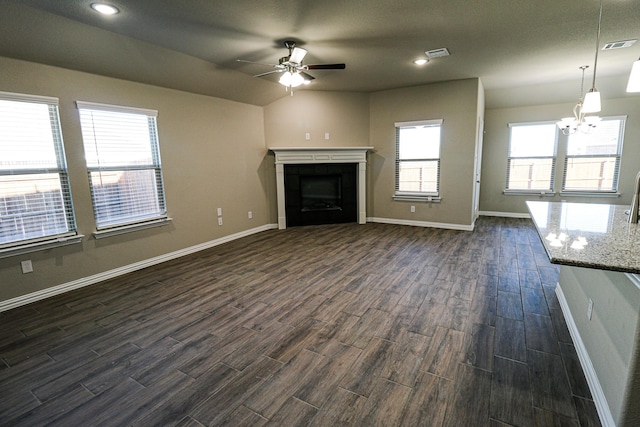 504 Lakeway Ln, Justin, TX 76247 - unfurnished living room featuring a ceiling fan, dark wood finished floors, a chandelier, baseboards, and recessed lighting
