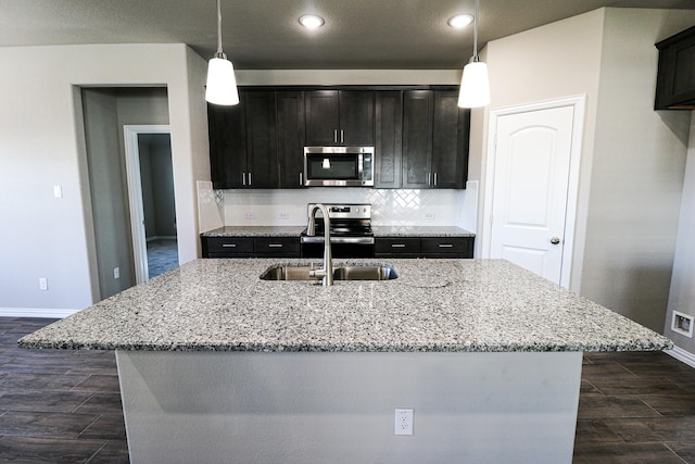 504 Lakeway Ln, Justin, TX 76247 - kitchen with stainless steel appliances, baseboards, dark wood-style floors, light stone countertops, and recessed lighting