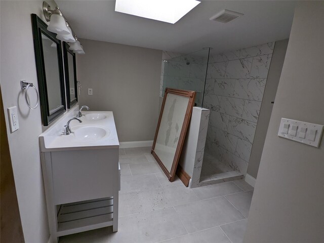 bathroom with a walk in shower, double vanity, tile patterned flooring, and baseboards