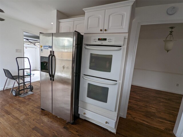 kitchen with stainless steel fridge with ice dispenser, white double oven, dark wood-style flooring, and white cabinets
