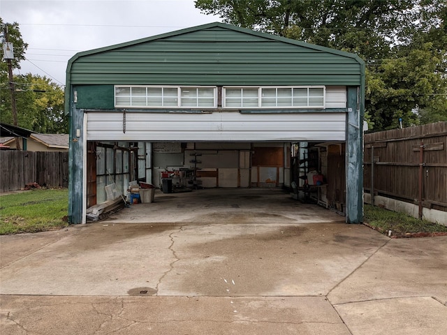 garage with driveway and fence