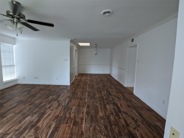 unfurnished room featuring ornamental molding, ceiling fan, dark wood-style flooring, and baseboards
