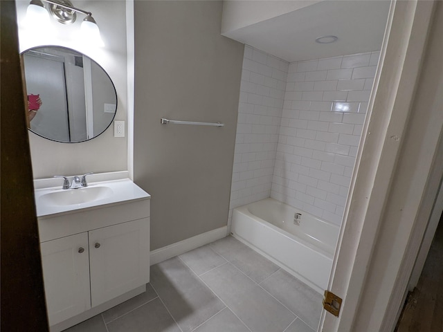 full bath with tile patterned flooring, vanity, baseboards, and bathtub / shower combination