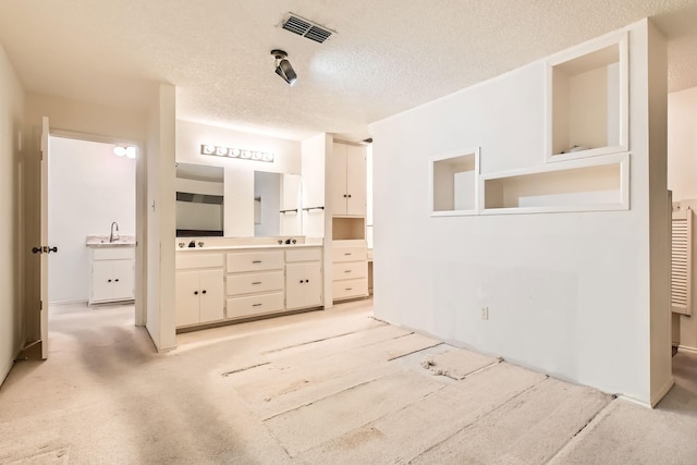 107 San Medina Ln, Joshua, TX 76058 - bathroom with a textured ceiling and double vanity
