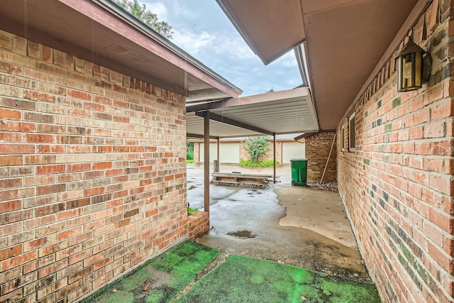 107 San Medina Ln, Joshua, TX 76058 - view of side of home with brick siding and a patio area
