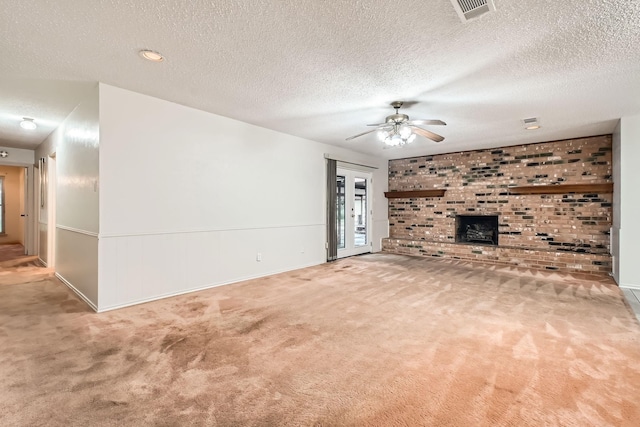 107 San Medina Ln, Joshua, TX 76058 - unfurnished living room featuring carpet floors, a textured ceiling, a ceiling fan, a fireplace, and baseboards