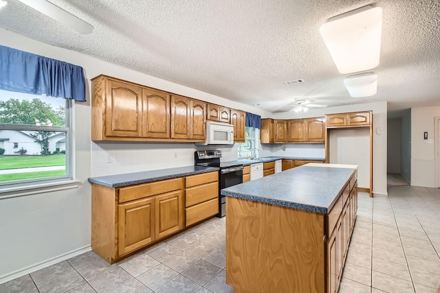 107 San Medina Ln, Joshua, TX 76058 - kitchen featuring white appliances, a ceiling fan, dark countertops, a textured ceiling, and light tile patterned flooring
