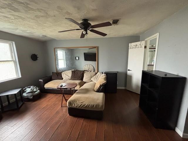 2220 N Clements St, Gainesville, TX 76240 - living room with a ceiling fan, dark wood finished floors, a textured ceiling, and baseboards