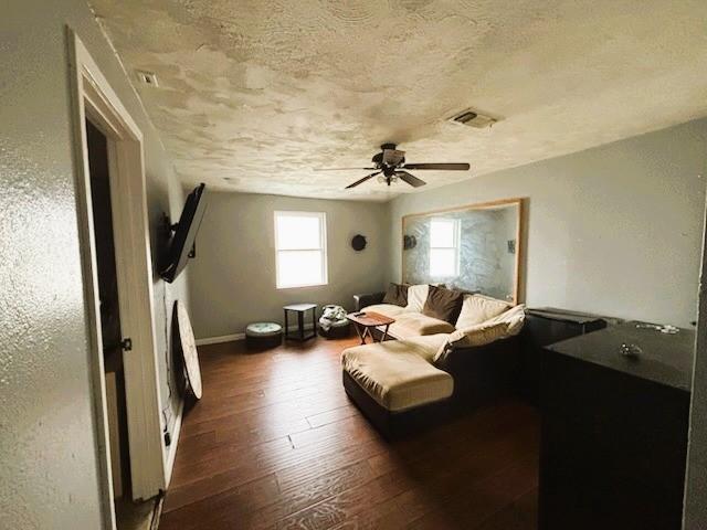 2220 N Clements St, Gainesville, TX 76240 - living room with a textured ceiling, wood-type flooring, ceiling fan, and baseboards