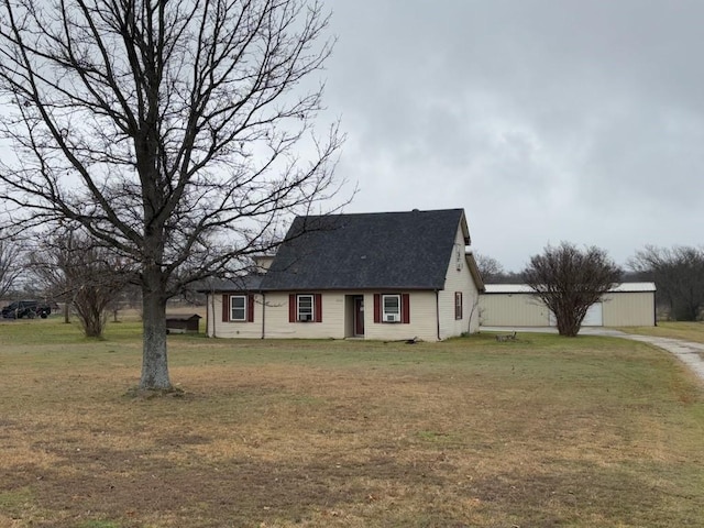 2220 N Clements St, Gainesville, TX 76240 - view of front of house with a front yard, a shingled roof, and driveway