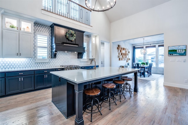 5208 Westfield Dr, Parker, TX 75002 - kitchen featuring a chandelier, a breakfast bar area, a sink, light countertops, and a kitchen island with sink