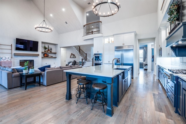 5208 Westfield Dr, Parker, TX 75002 - kitchen with high vaulted ceiling, stainless steel appliances, a chandelier, a sink, and open floor plan