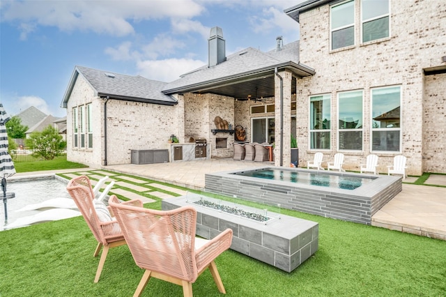 5208 Westfield Dr, Parker, TX 75002 - back of house featuring a patio area, an outdoor kitchen, a fire pit, a chimney, and a yard