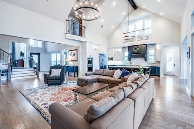5208 Westfield Dr, Parker, TX 75002 - living room with a chandelier, high vaulted ceiling, stairs, light wood finished floors, and beamed ceiling
