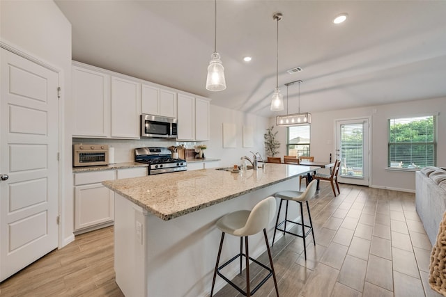 148 Greenback Trl, Fort Worth, TX 76131 - kitchen featuring appliances with stainless steel finishes, a sink, white cabinetry, light stone countertops, and recessed lighting