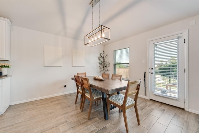 148 Greenback Trl, Fort Worth, TX 76131 - dining space featuring baseboards, light wood finished floors, and a chandelier