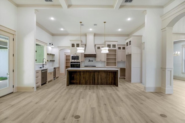 14541 Woodland Crk, Tyler, TX 75706 - kitchen featuring stainless steel appliances, arched walkways, open shelves, a kitchen island, and custom range hood
