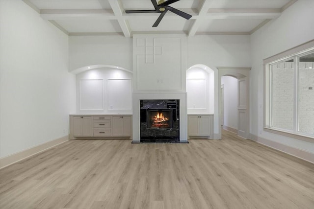 14541 Woodland Crk, Tyler, TX 75706 - unfurnished living room featuring coffered ceiling, a ceiling fan, light wood-type flooring, a fireplace, and beamed ceiling