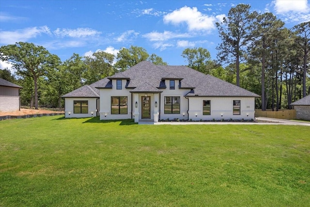 14541 Woodland Crk, Tyler, TX 75706 - view of front of home with a front lawn, a shingled roof, and stucco siding
