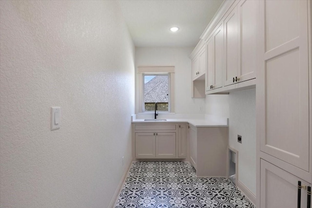 14541 Woodland Crk, Tyler, TX 75706 - clothes washing area with cabinet space, baseboards, hookup for an electric dryer, a textured wall, and light tile patterned floors