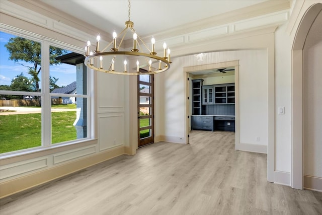 14541 Woodland Crk, Tyler, TX 75706 - unfurnished dining area with a chandelier, light wood-style flooring, baseboards, and healthy amount of natural light