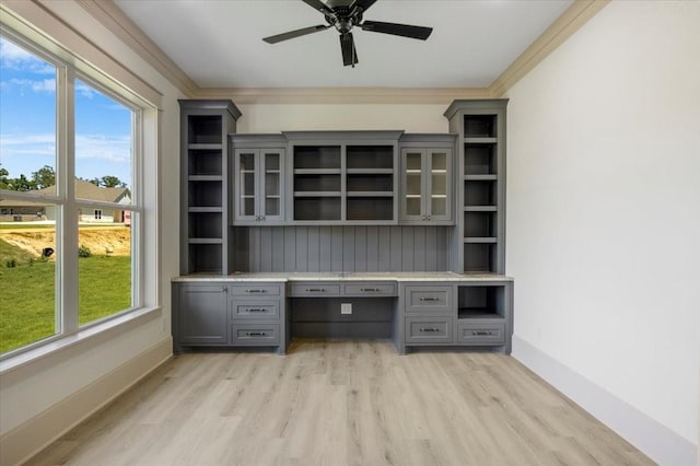 14541 Woodland Crk, Tyler, TX 75706 - unfurnished office featuring light wood-style floors, baseboards, ceiling fan, crown molding, and built in study area