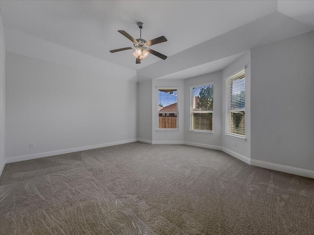 empty room featuring carpet flooring, a ceiling fan, and baseboards