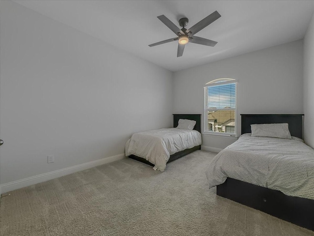 bedroom featuring baseboards, carpet floors, and a ceiling fan