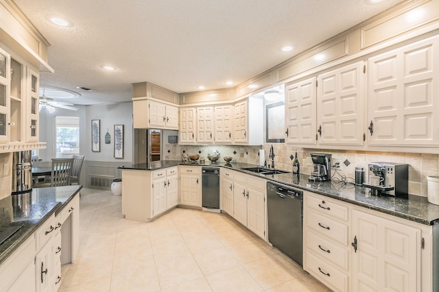 kitchen featuring dishwasher, a sink, a peninsula, a ceiling fan, and backsplash
