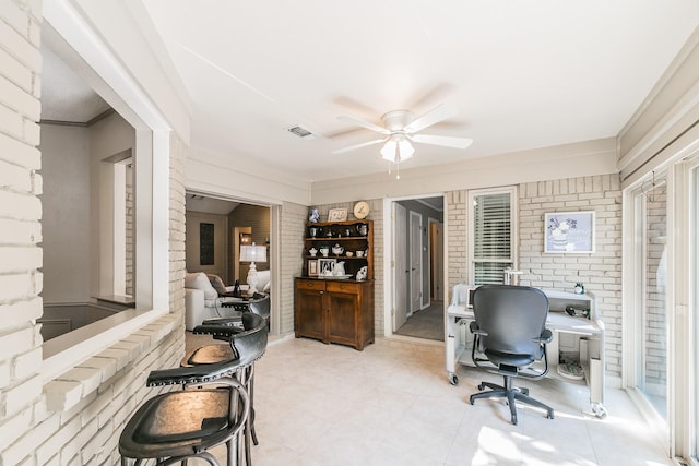 2314 Wakeforest Ct, Arlington, TX 76012 - office space featuring a ceiling fan, brick wall, and light tile patterned floors