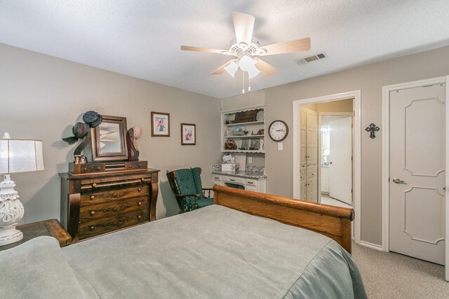 bedroom featuring light carpet and a ceiling fan
