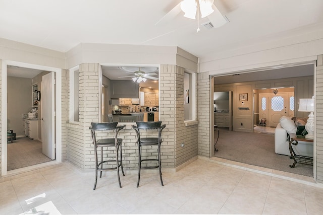 view of patio / terrace with a bar and ceiling fan
