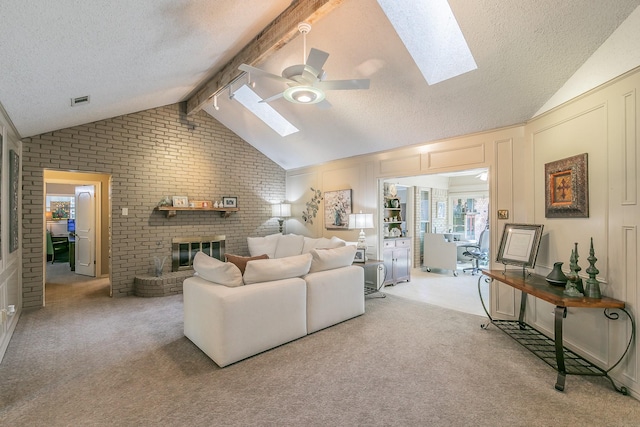 2314 Wakeforest Ct, Arlington, TX 76012 - living area with a skylight, a ceiling fan, a textured ceiling, a fireplace, and brick wall