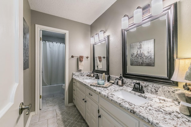 2314 Wakeforest Ct, Arlington, TX 76012 - bathroom featuring double vanity, toilet, a textured ceiling, and shower / bath combo