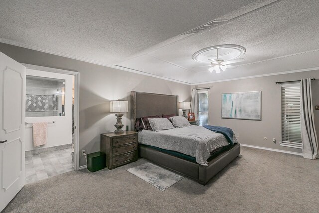 carpeted bedroom with a textured ceiling, baseboards, crown molding, and ensuite bathroom