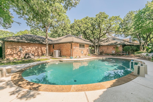 view of swimming pool featuring central AC and a patio