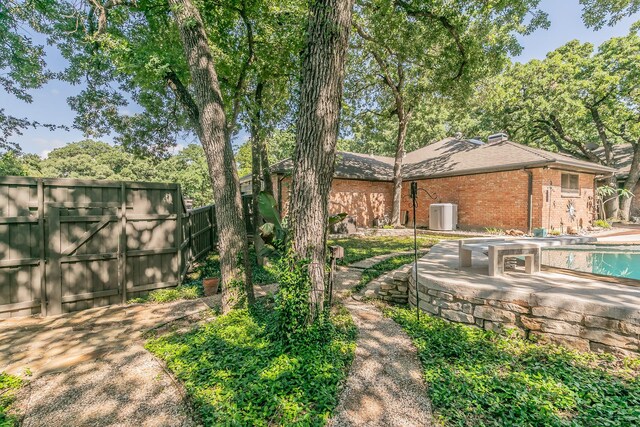 view of yard featuring fence, a patio area, a gate, and a swimming pool