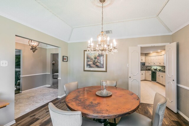 dining area featuring a chandelier, light wood finished floors, and ornamental molding