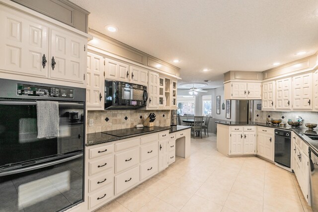 kitchen with black appliances, tasteful backsplash, glass insert cabinets, recessed lighting, and a peninsula
