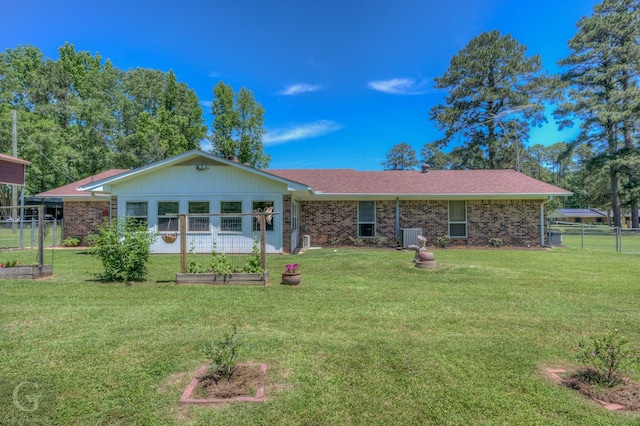 451 Burney St, Coushatta, LA 71019 - back of house with a garden, brick siding, central AC, and roof with shingles