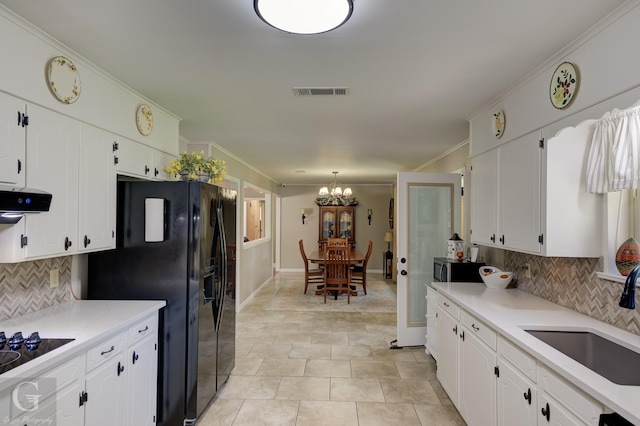 451 Burney St, Coushatta, LA 71019 - kitchen featuring a sink, backsplash, a chandelier, black appliances, and crown molding