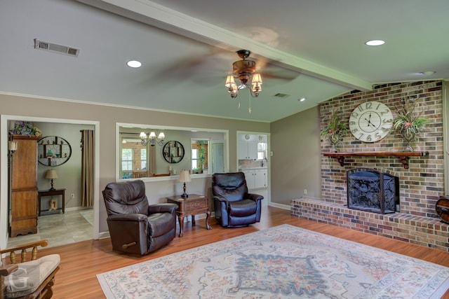 451 Burney St, Coushatta, LA 71019 - living area featuring a ceiling fan, a chandelier, wood finished floors, a brick fireplace, and baseboards