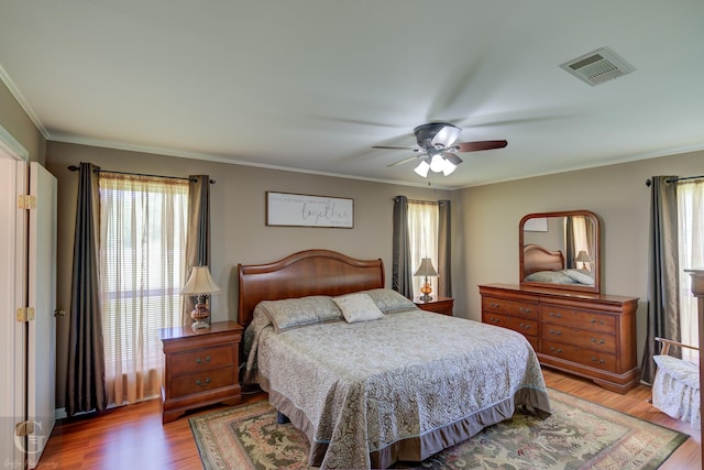 451 Burney St, Coushatta, LA 71019 - bedroom featuring multiple windows, light wood-style flooring, ceiling fan, and ornamental molding