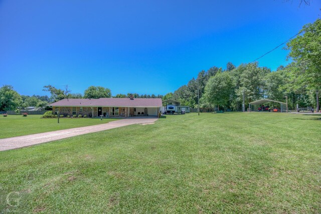 451 Burney St, Coushatta, LA 71019 - view of front of house with a front yard, a carport, and concrete driveway