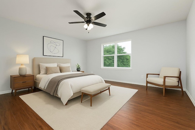 1315 Falcon Dr, Lewisville, TX 75077 - bedroom with baseboards, dark wood-type flooring, and a ceiling fan