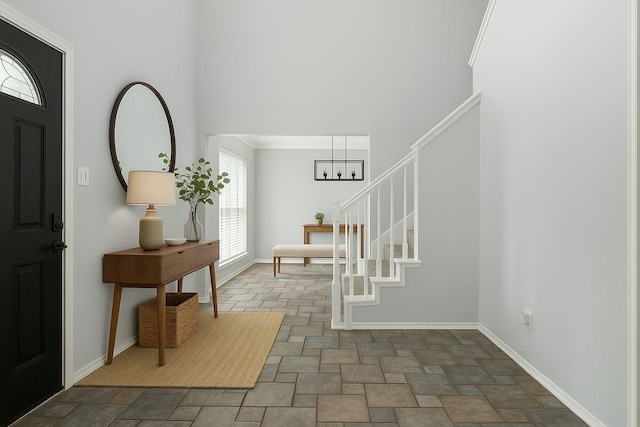 1315 Falcon Dr, Lewisville, TX 75077 - entrance foyer featuring stone finish flooring, stairs, baseboards, a towering ceiling, and crown molding