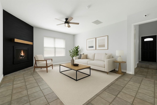 1315 Falcon Dr, Lewisville, TX 75077 - living room with a ceiling fan, light tile patterned floors, a large fireplace, and baseboards
