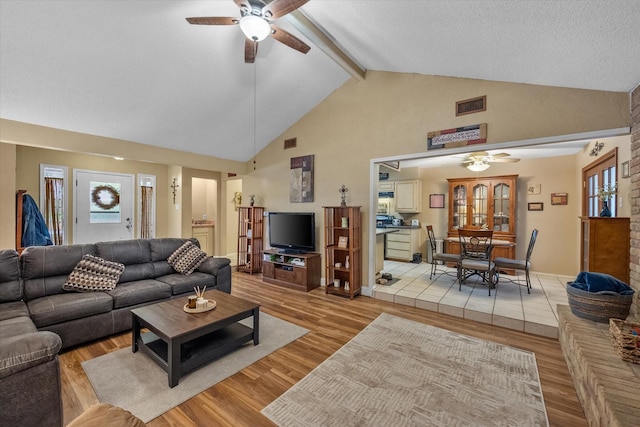 5807 Melstone Dr, Arlington, TX 76016 - living room featuring a ceiling fan, beamed ceiling, light wood-style flooring, and high vaulted ceiling