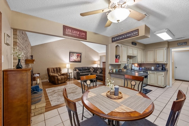 dining space with a textured ceiling, light tile patterned floors, a ceiling fan, and baseboards